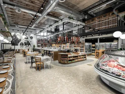 Industrial-themed restaurant with concrete floors and concrete pillars