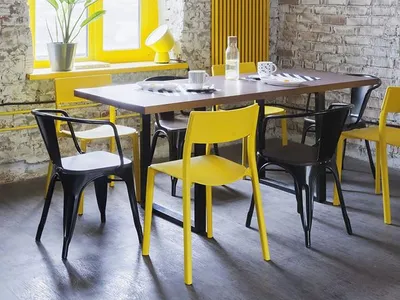 A modern industrial restaurant interior with a yellow brick wall