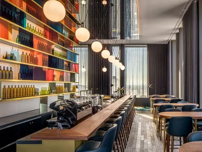Modern restaurant interior with contemporary furniture and lighting.