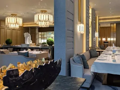 Modern restaurant interior with marble accents and elegant lighting.
