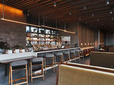 A modern restaurant bar interior featuring wooden walls, leather seating, and concrete flooring.