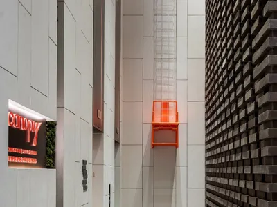 Modern minimalist hotel entryway with metallic accent