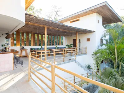 An outdoor restaurant patio featuring timber and concrete elements.