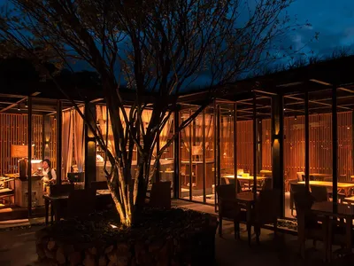 Modern restaurant interior featuring wooden elements and a warm, inviting atmosphere.