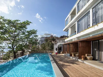 Modern resort with glass floor tiles and outdoor pool area, featuring a contemporary hotel design.