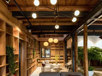 An industrial-style living room featuring wooden materials and a comfortable seating area.