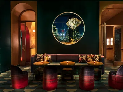 Industrial-style restaurant bar featuring metal, glass, and fabric elements.