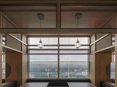 A minimalist restaurant dining room featuring wood and leather materials.