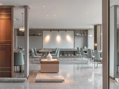Modern lobby design featuring contemporary furniture and lighting in a sleek, minimalist space with mixed materials like glas