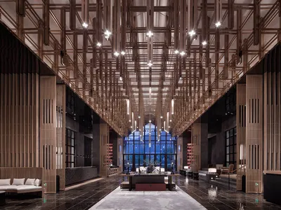 An interior view of a modern hotel lobby featuring marble flooring and a wooden frame
