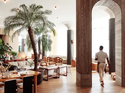 Modern restaurant interior with wooden walls and furniture, plants, and contemporary decor.
