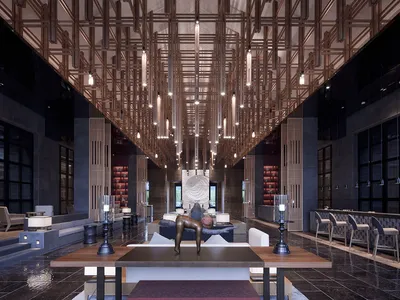 Modern hotel reception lobby featuring metallic lighting and concrete architecture