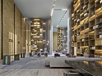 Modern hotel lobby featuring metallic furniture and high-quality lighting.