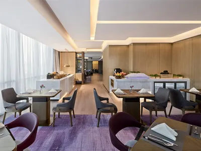 Modern interior of a restaurant featuring wood and marble materials and contemporary design elements