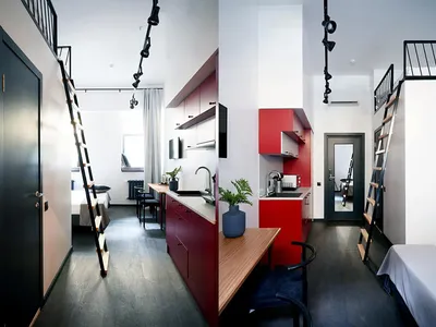 Minimalist residential interior featuring a red kitchen area with an open-plan living space and loft bed.