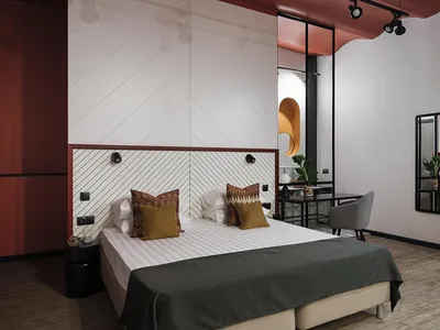 A minimalist bedroom with a white bed, taupe accents, and a minimalist design.