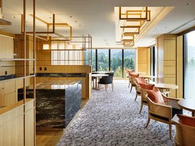 Hotel suite with modern interior design featuring wood and marble elements.