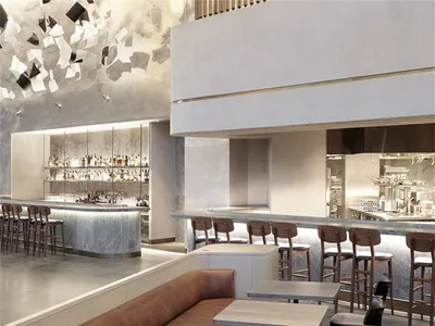 A modern restaurant bar with concrete, marble, wooden, and leather elements.