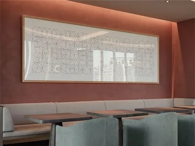 A modern restaurant interior featuring concrete furniture and a geometric wall art piece.