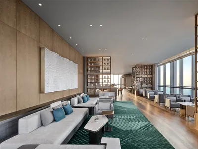 Modern hotel lounge featuring contemporary furniture with wooden, tiled, and concrete finishes.