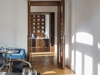 Interior view of a modern restaurant featuring wooden flooring and contemporary furniture.