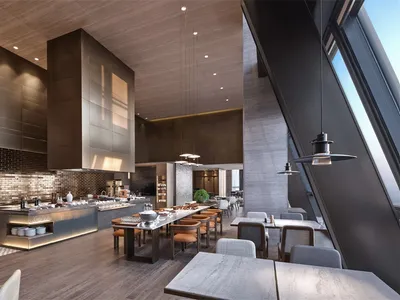 Modern restaurant interior featuring metallic finishes, glass countertops, and wooden furnishings.