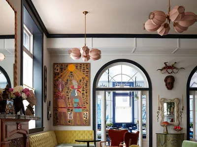 A bohemian-style living room with vibrant textiles, eclectic furniture, and intricate design elements.