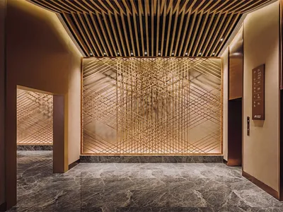 Modern hotel lobby featuring metal, glass, and marble materials.