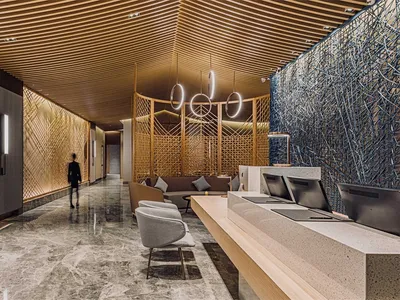 Modern hotel reception area featuring wood cladding, marble accents, and cement floors.