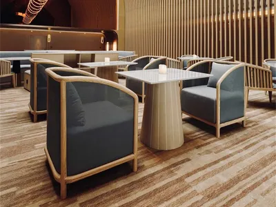 A modern restaurant bar featuring a textured wood interior design.