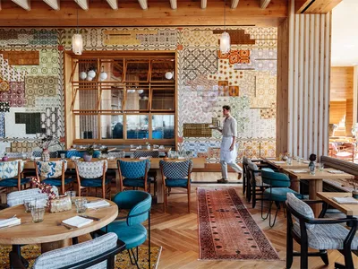 Modern restaurant interior with patterned tiles and wooden elements.