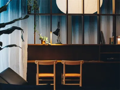 Modern home office with wooden furniture, plants, and a cozy atmosphere