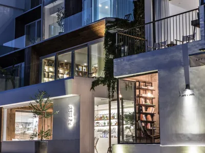 A modern restaurant with concrete and glass exterior features.