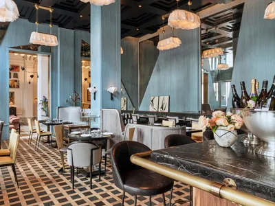 Modern casual dining room with metallic furniture and cyan accent walls