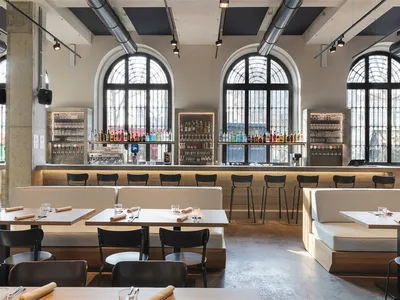 Modern restaurant interior with concrete and glass features