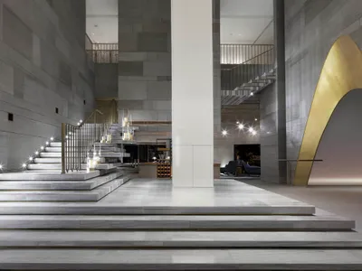 A luxurious modern hotel lobby with marble finishes and sophisticated design elements.