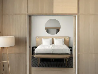 A modern bedroom with a bamboo bed and minimalistic decor.