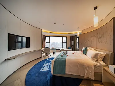 Contemporary bedroom suite with neutral-toned tufted wall paneling and a minimalist design.