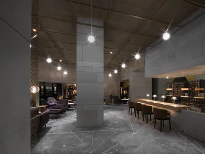 現代酒店酒吧，設有混凝土休息區，搭配當代座椅配置與精緻設計。