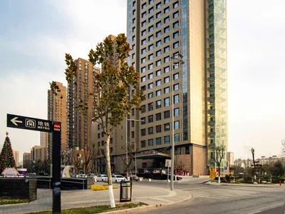 Modern hotel building with glass and concrete exterior.