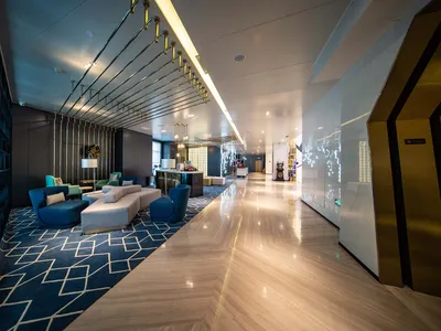 A modern hotel lobby featuring marble and concrete materials.