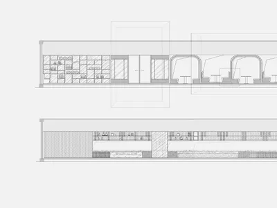Sectional view of a modern restaurant interior showcasing the counter and bar area with concrete finishes and sleek, industri
