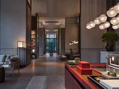 A minimalist hotel lobby featuring modern furniture and lighting.