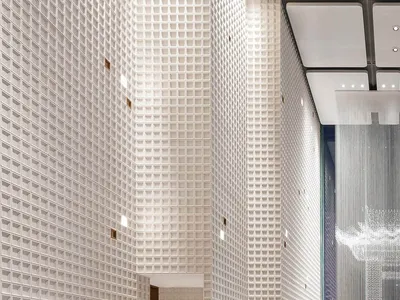 Modern hotel lobby with glass walls, concrete floor, and metallic accents.