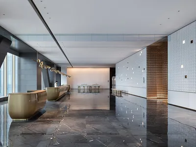 Modern hotel lobby featuring marble and metal surfaces.