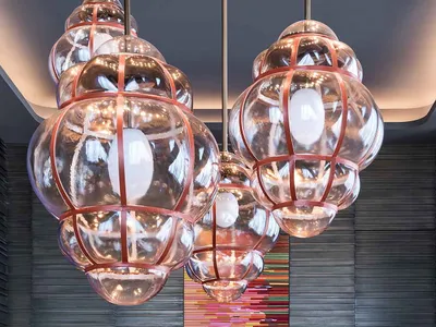 Modern restaurant interior with hanging glass chandeliers and a centerpiece display.