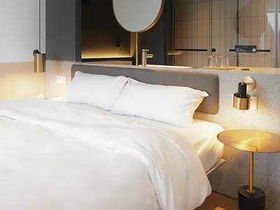 A modern bedroom with a white bed, concrete walls, and a circular mirror.
