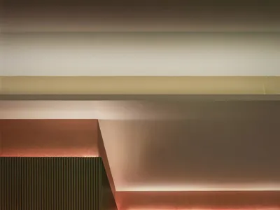 A modern restaurant bar with metallic-texture walls and ceiling.