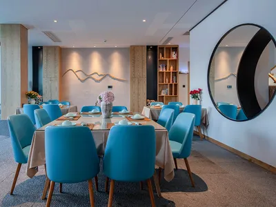 Modern blue leather chairs in a contemporary restaurant dining room setting with a contemporary design aesthetic.