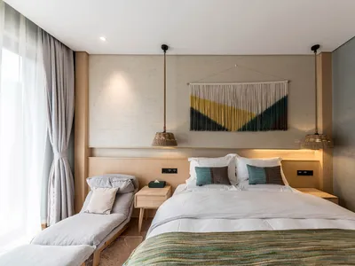 Modern minimalist bedroom featuring wooden furniture and concrete walls.